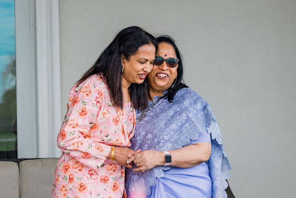 Two people sharing a close moment and laughing together outdoors.