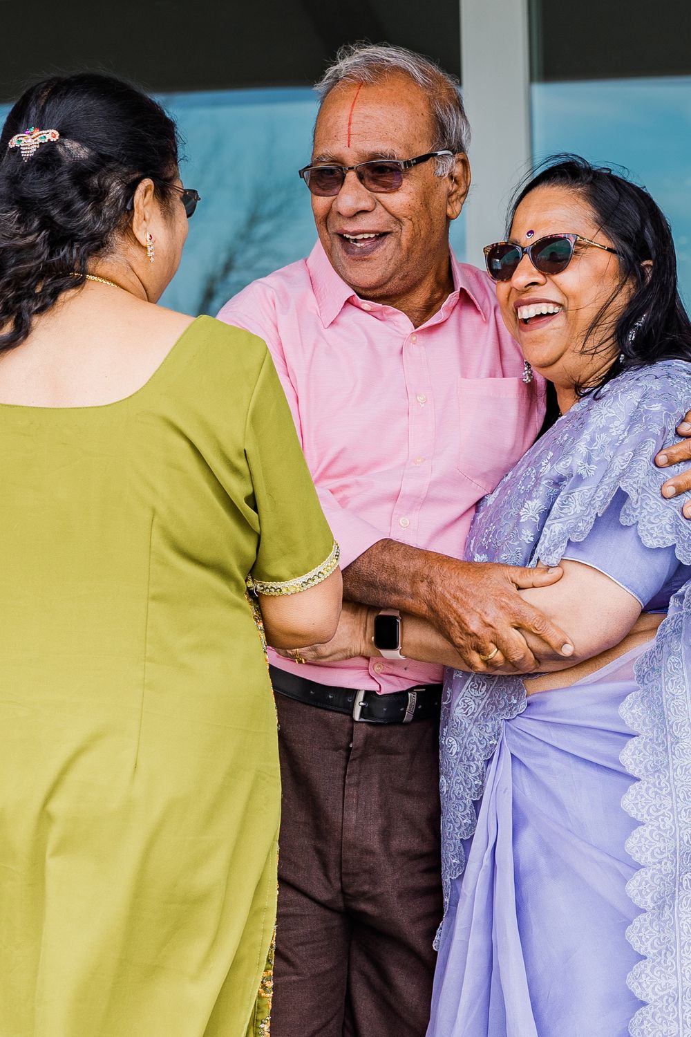 People sharing joyful laughter during an outdoor gathering.