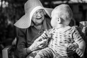 Black and white candid photography series capturing joyful outdoor family moments.