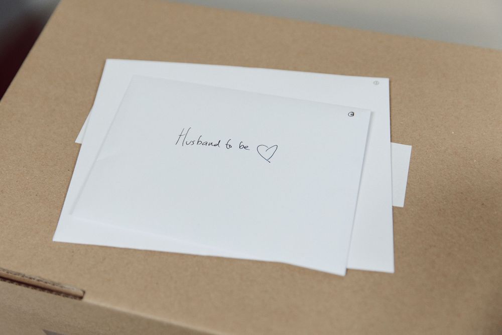 Close-up of handwritten notes on brown and white paper.