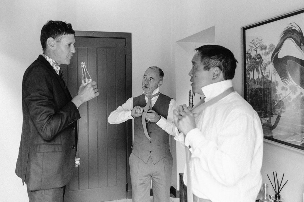 Black and white candid shots of wedding party preparations.