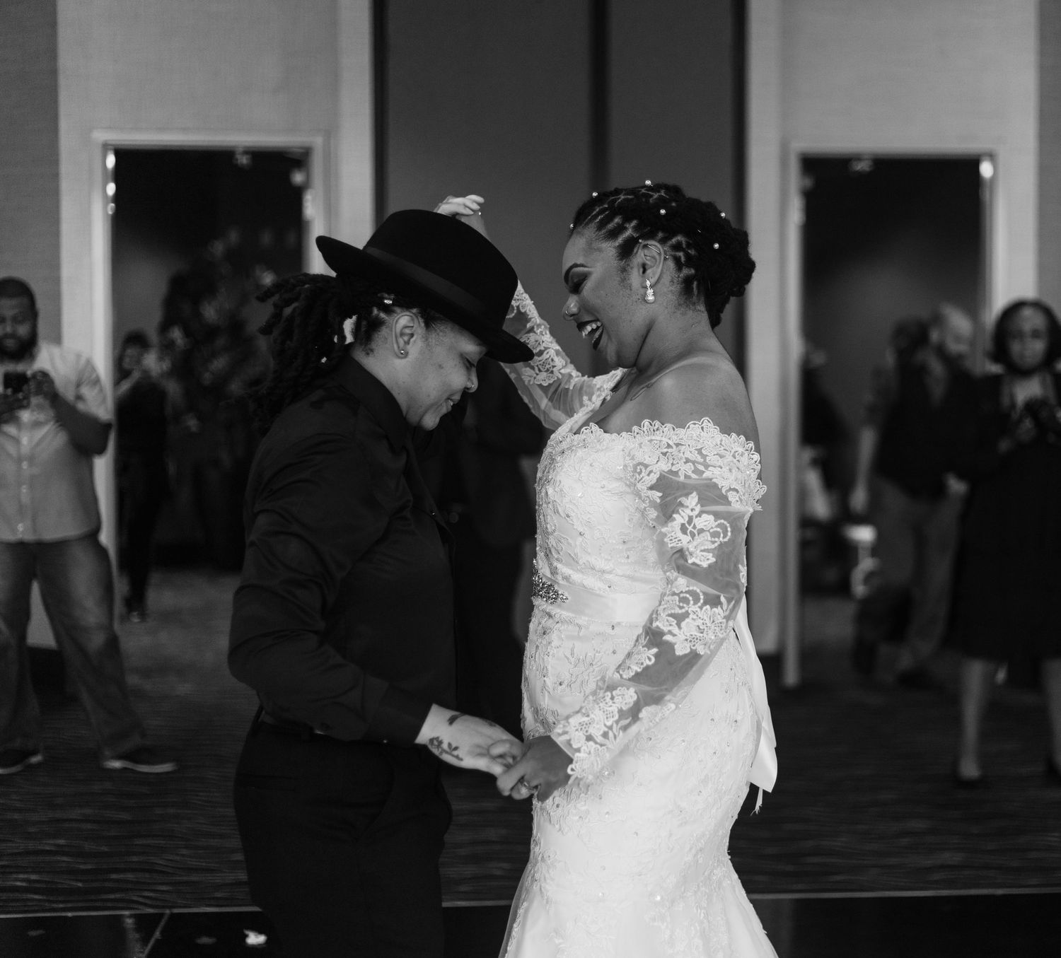 Black and white photo of two brides sharing an intimate dance at reception.