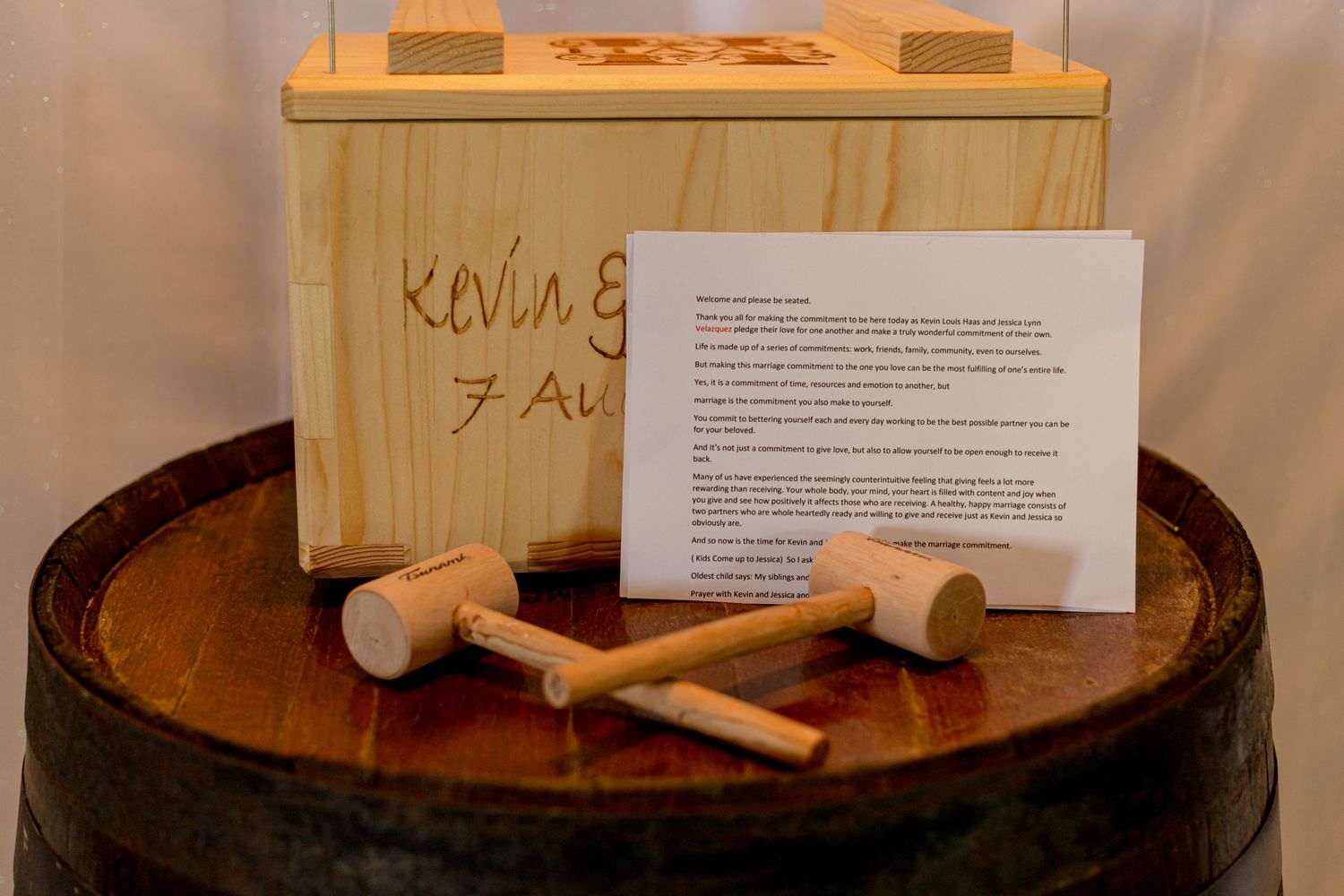 Wooden wedding time capsule box with mallets on a barrel, engraved with Kevin and date.