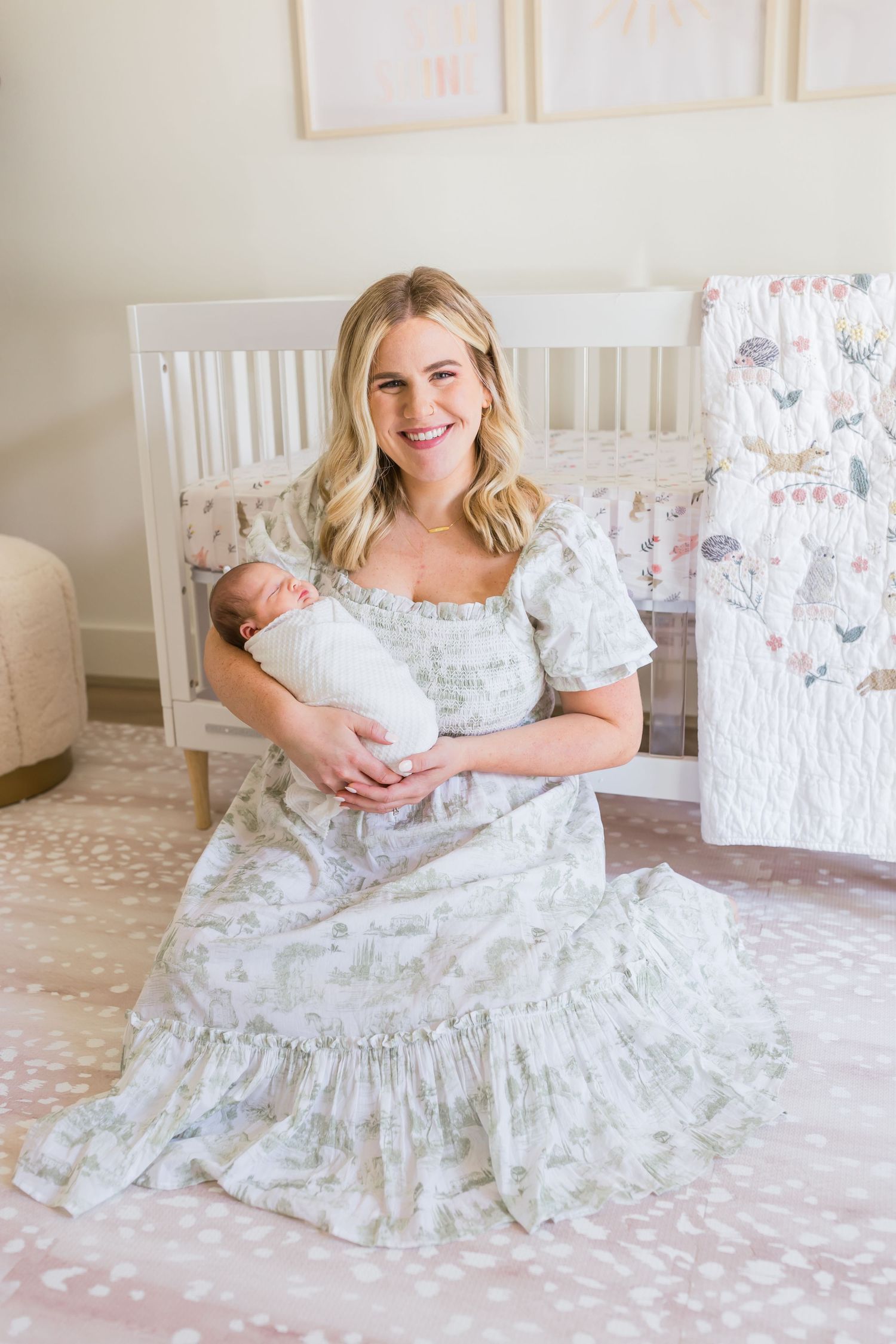 A joyful moment in a nursery with white crib and delicate floral bedding.