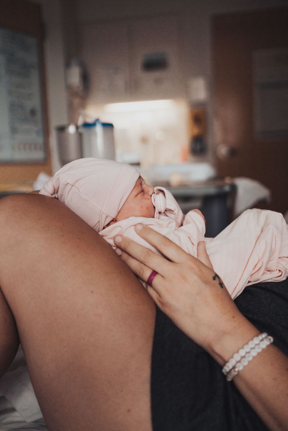Intimate hospital photo capturing first moments after birth.