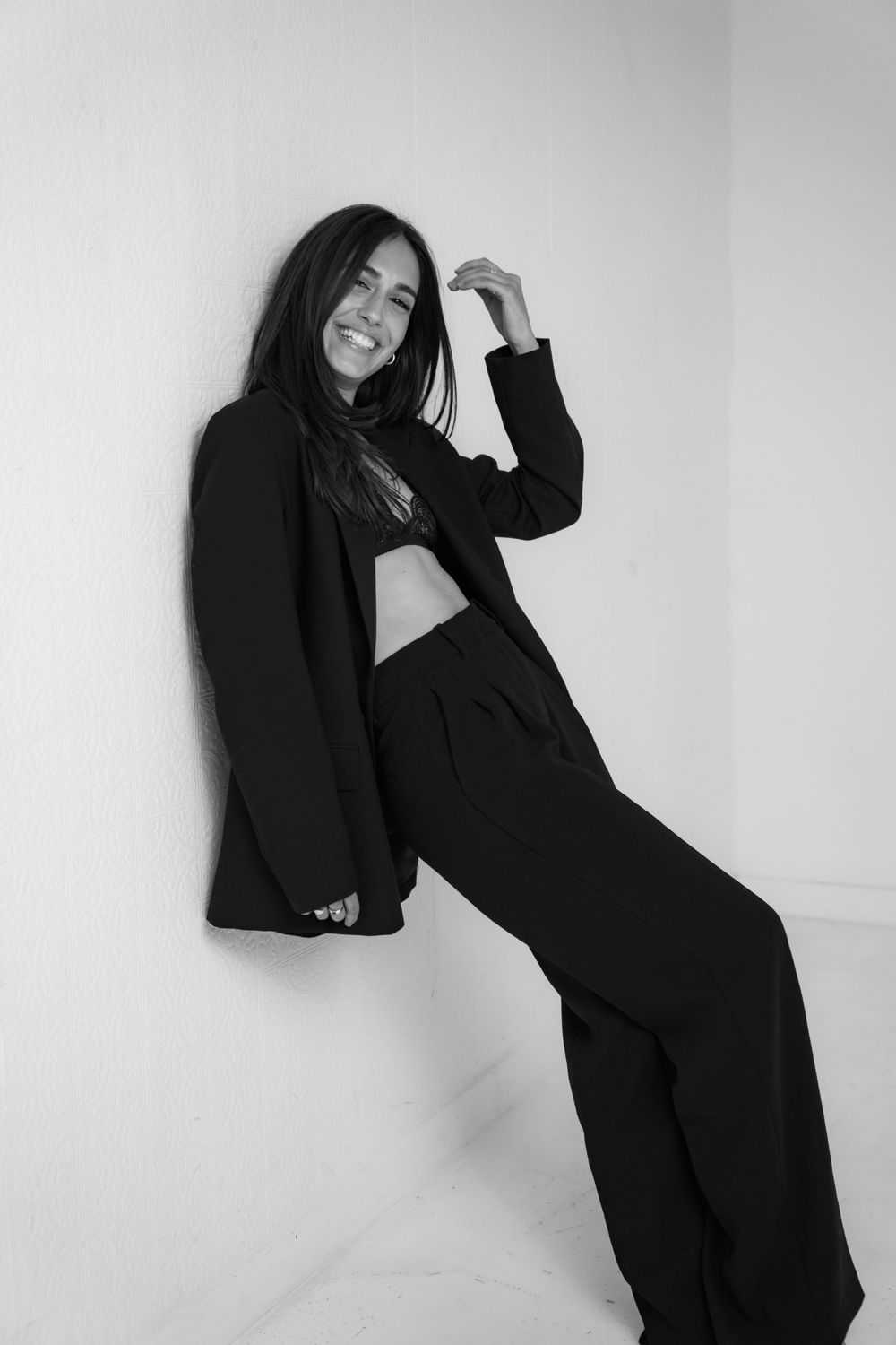 Artistic black and white photo series showing poses in dark oversized blazer.