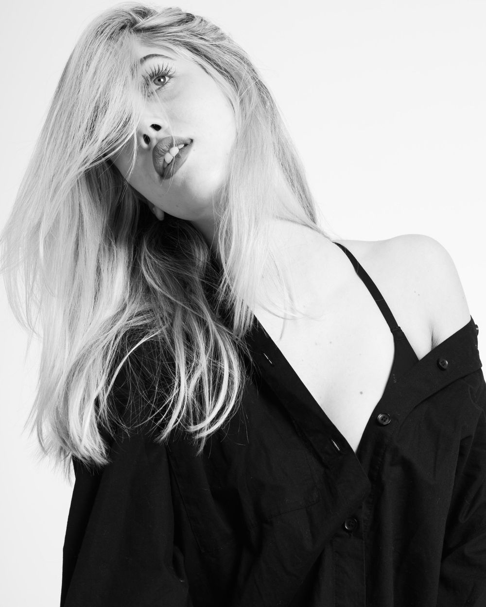 Black and white portrait series showing dramatic angles in dark clothing.