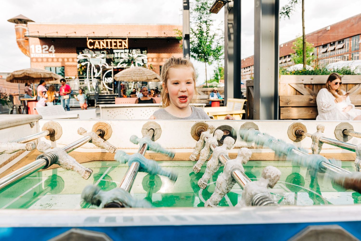 Girl playing foosball at Camp North End