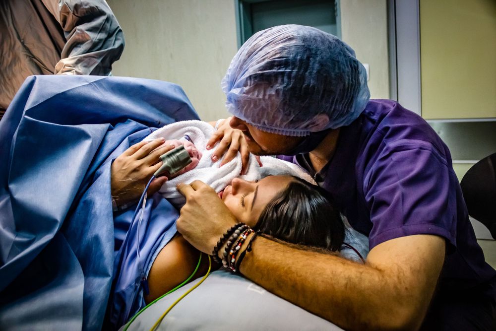birth photography newborn mom mediclinic theatre c-section cuddle parents doctor