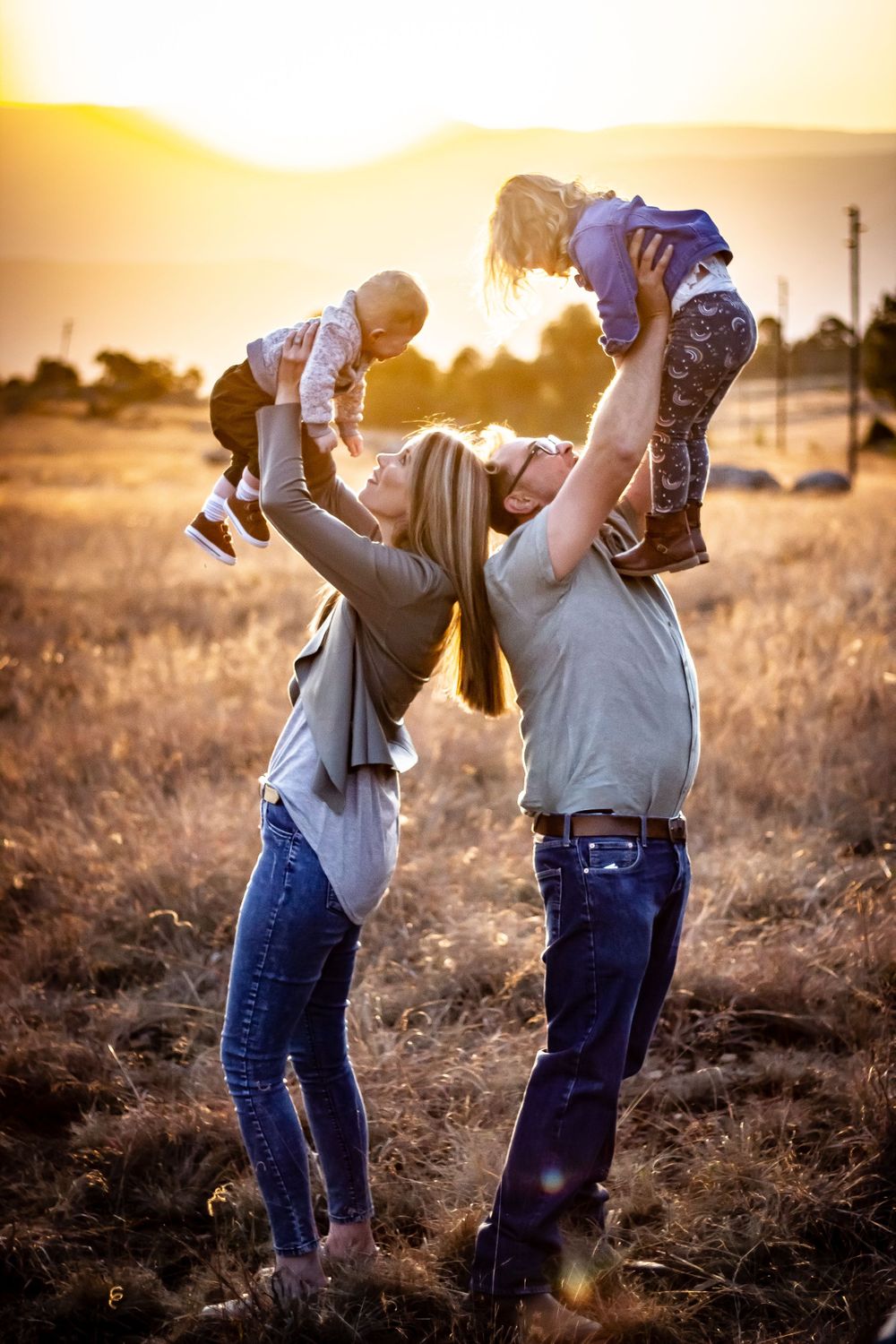 parents family photography children playing celebrating life happy sunset golden hour grass happy lifting kids dad mom