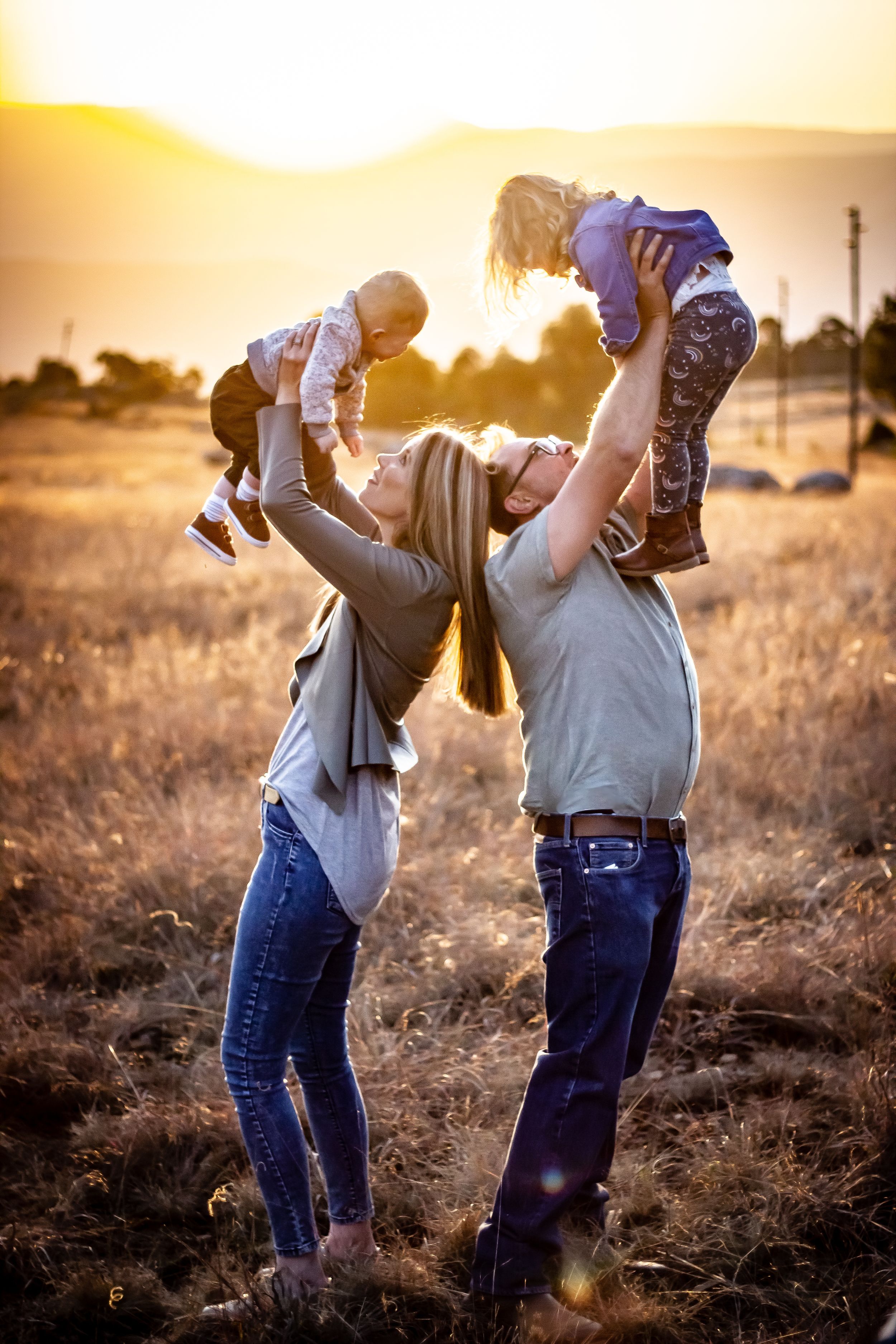 parents family photography children playing celebrating life happy sunset golden hour grass happy lifting kids dad mom