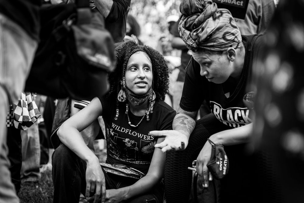 Black and white image of people engaged in animated discussion.