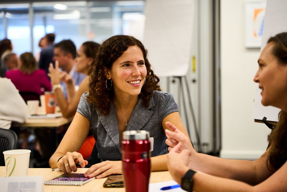 Two people having animated conversation at casual office meeting.