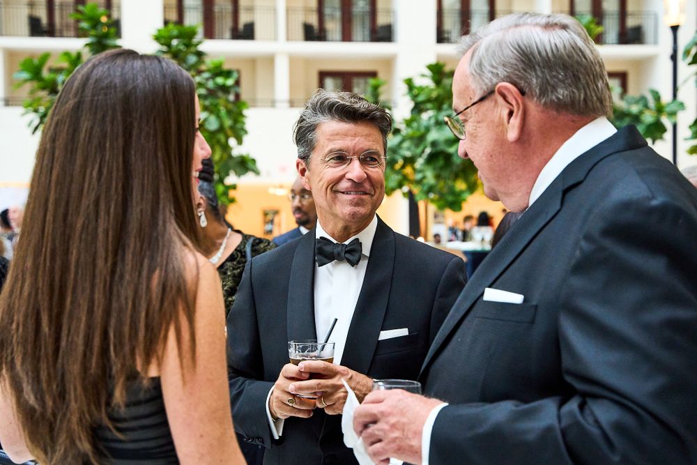 Guests engaged in conversation at an elegant cocktail reception.