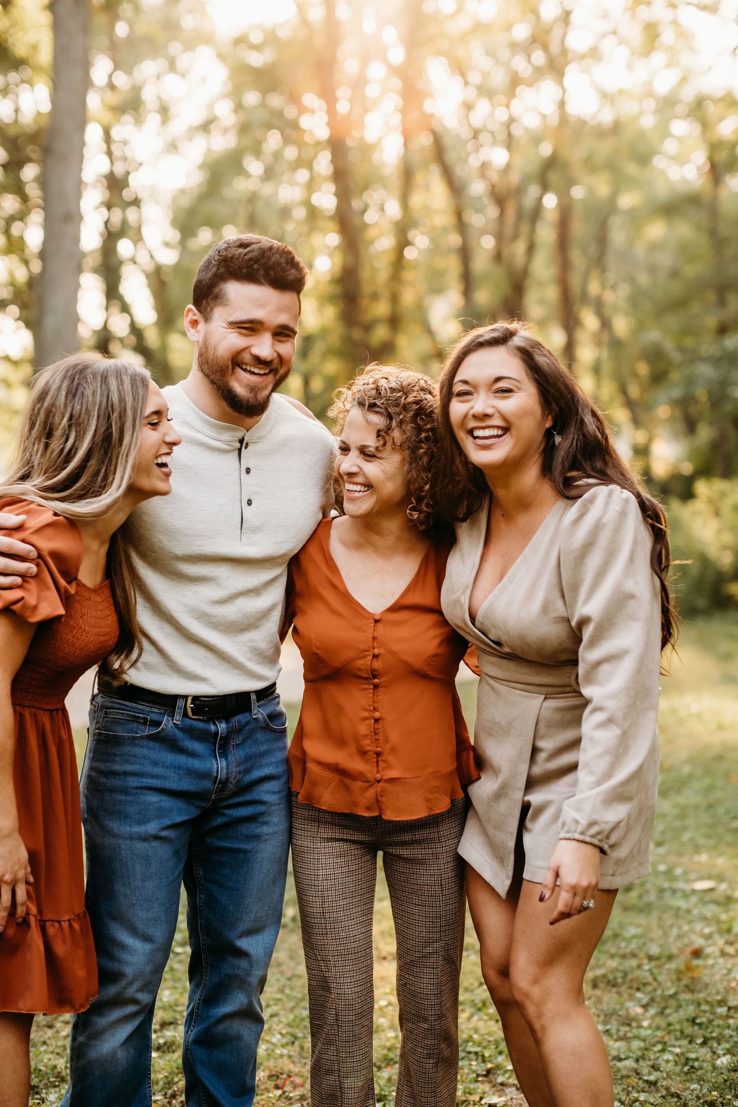 Family of four laughs together during family photography session in Bella Vista, Arkansas.
