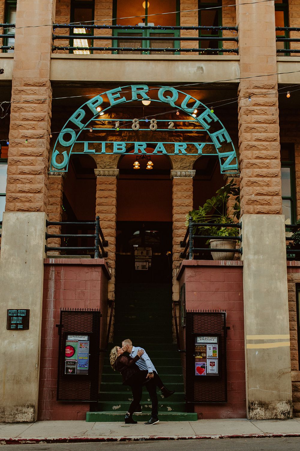 A couple shares a romantic moment outside the Cripple Creek Library.
