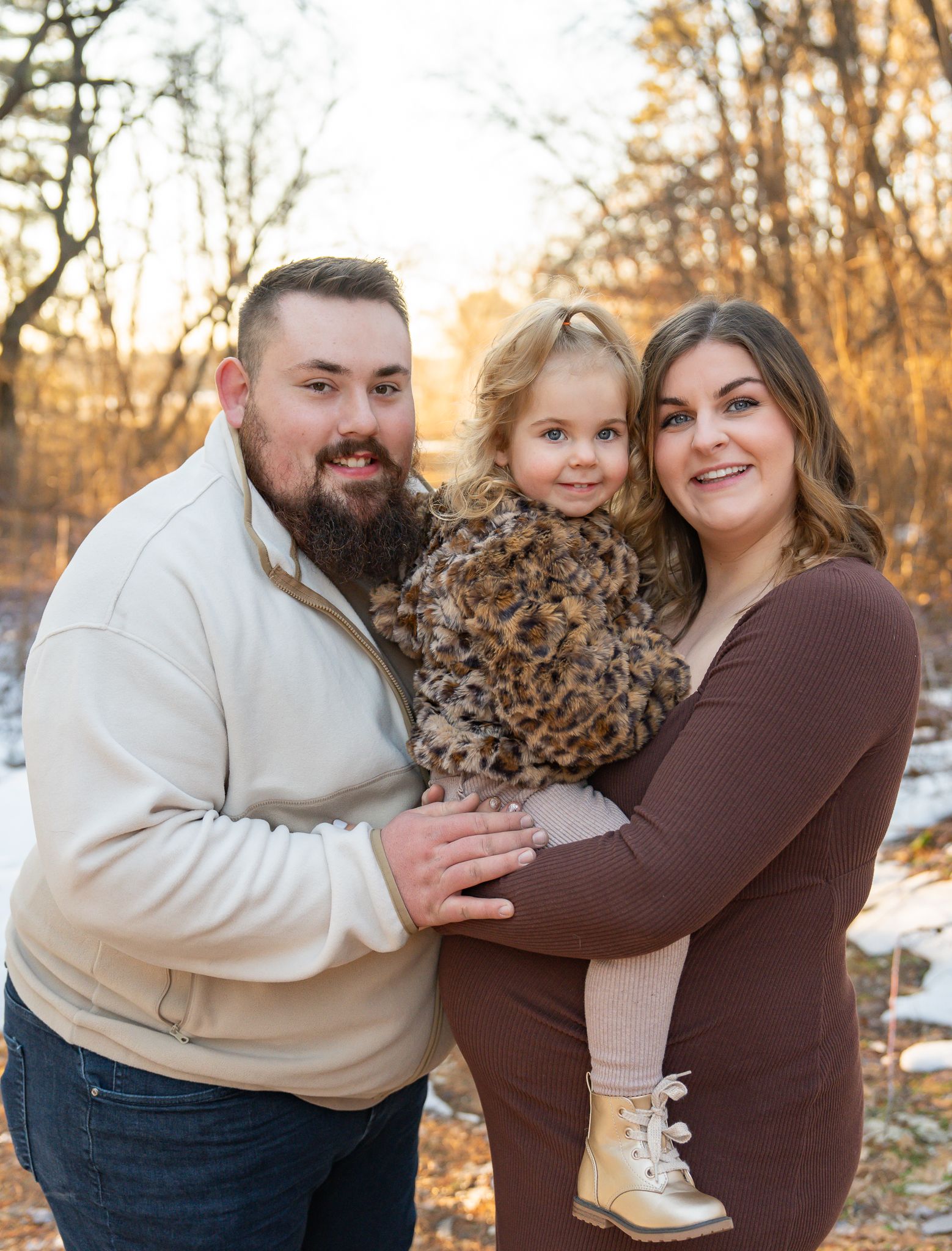 Family smiling excited to be expecting a new baby