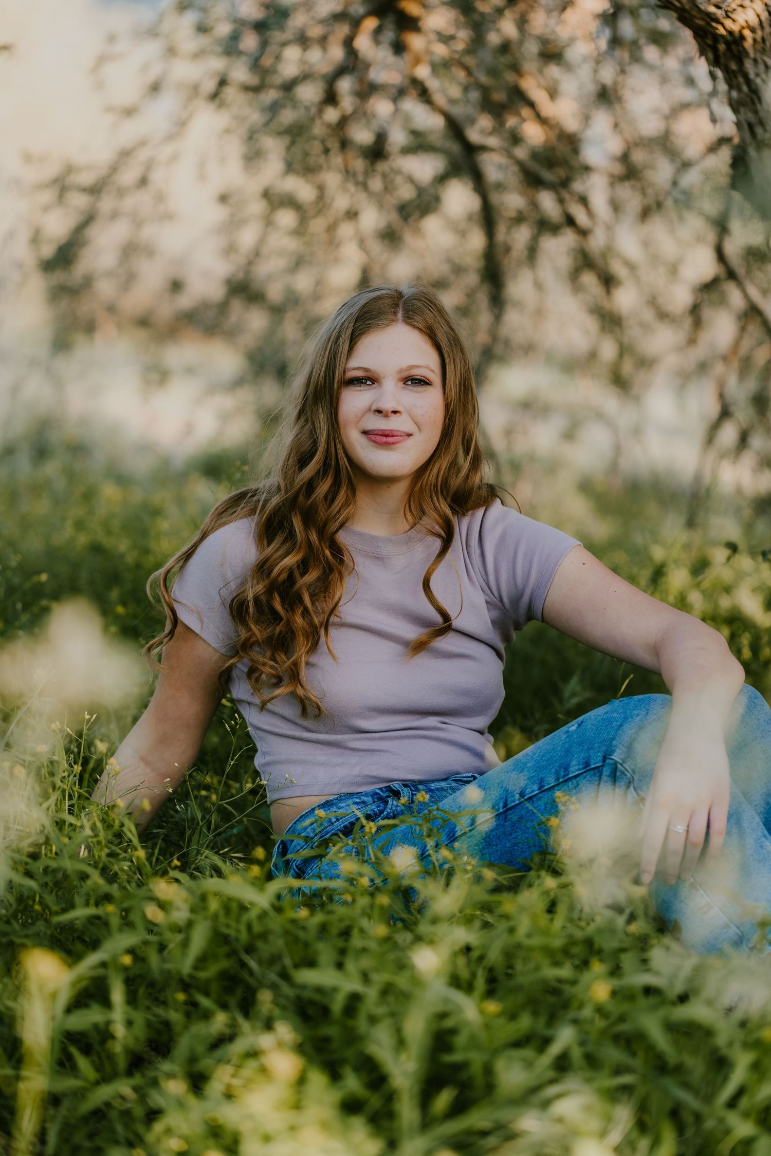 Relaxed outdoor photo session among green plants with soft natural lighting.