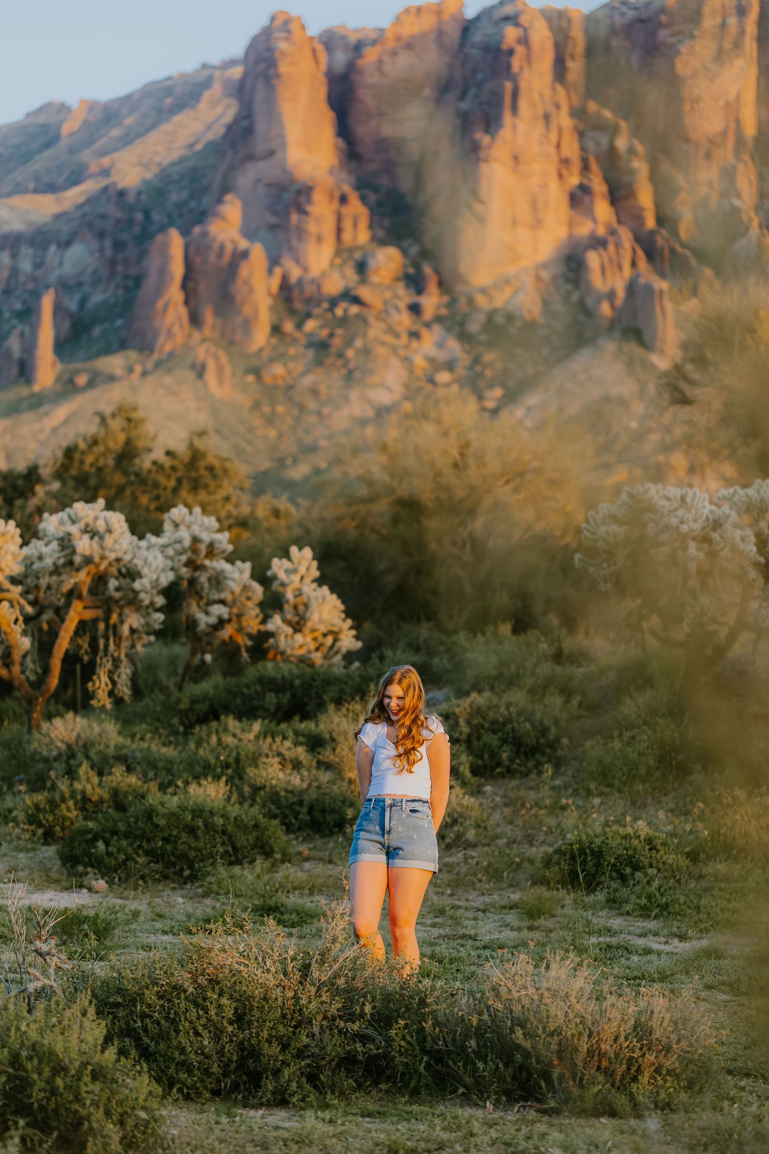 Desert landscape photography with dramatic mountain cliffs glowing orange at sunset.