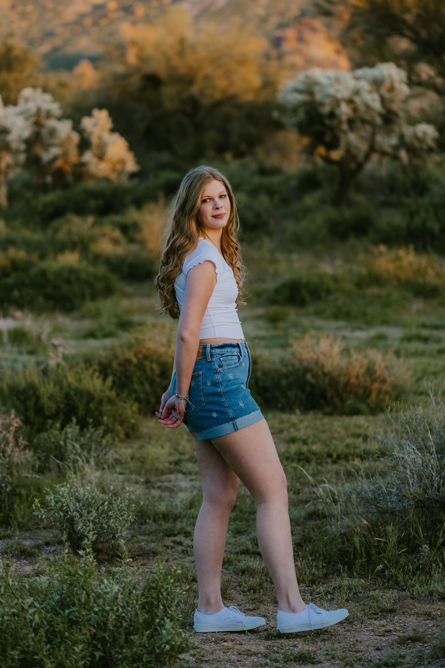 Casual outdoor portrait in desert landscape during golden hour.