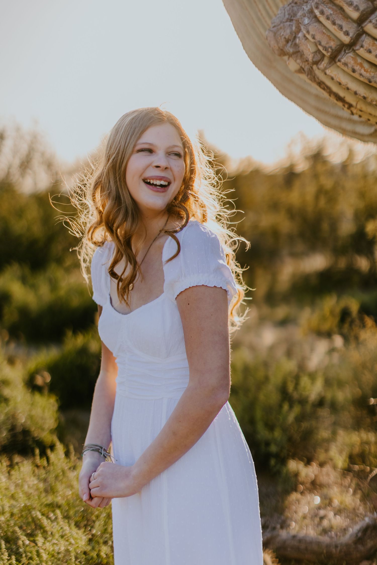 Joyful desert portrait with saguaro cactus during golden hour.