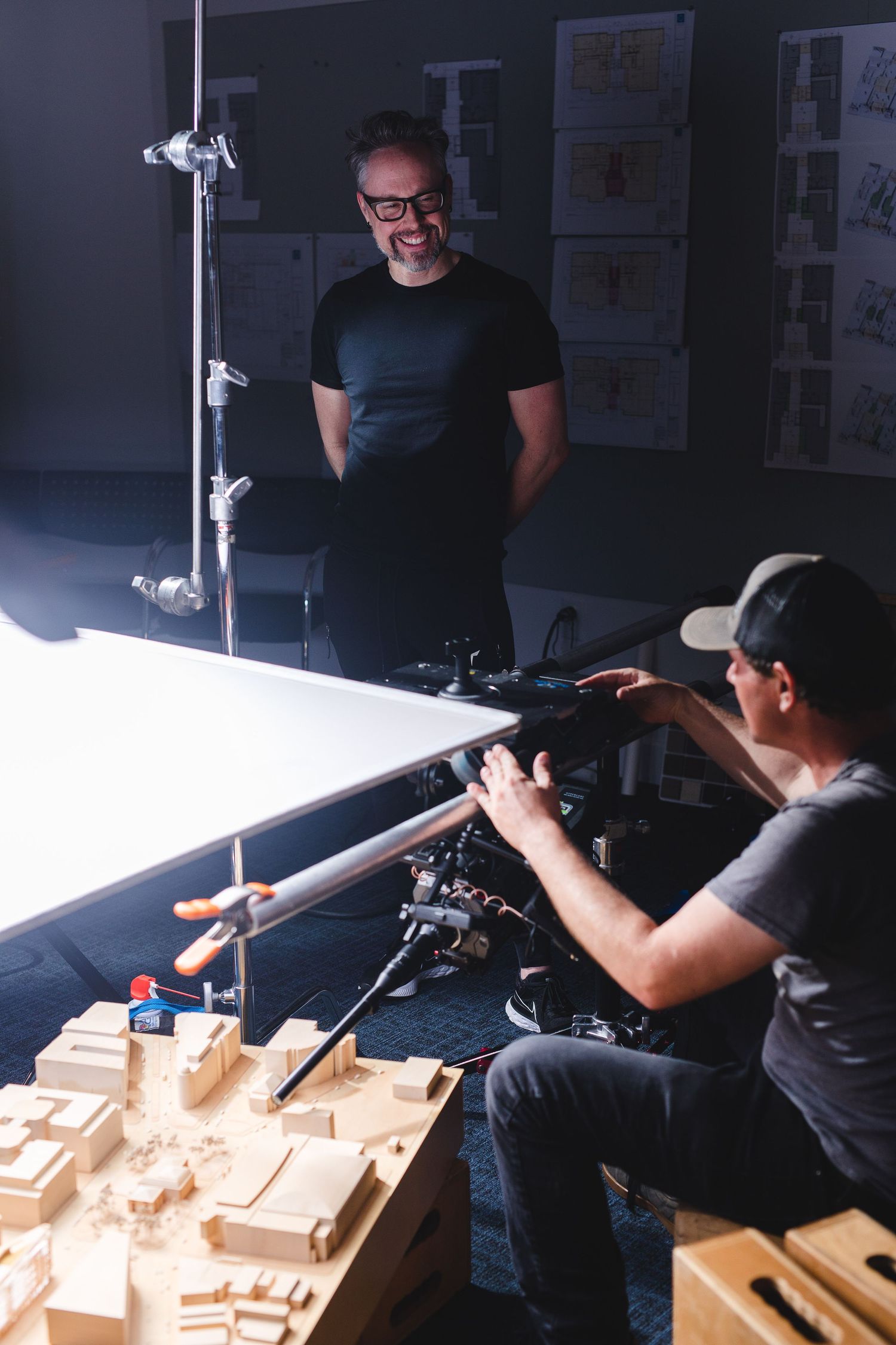 Behind the scenes product photography shoot with lighting setup and camera equipment.