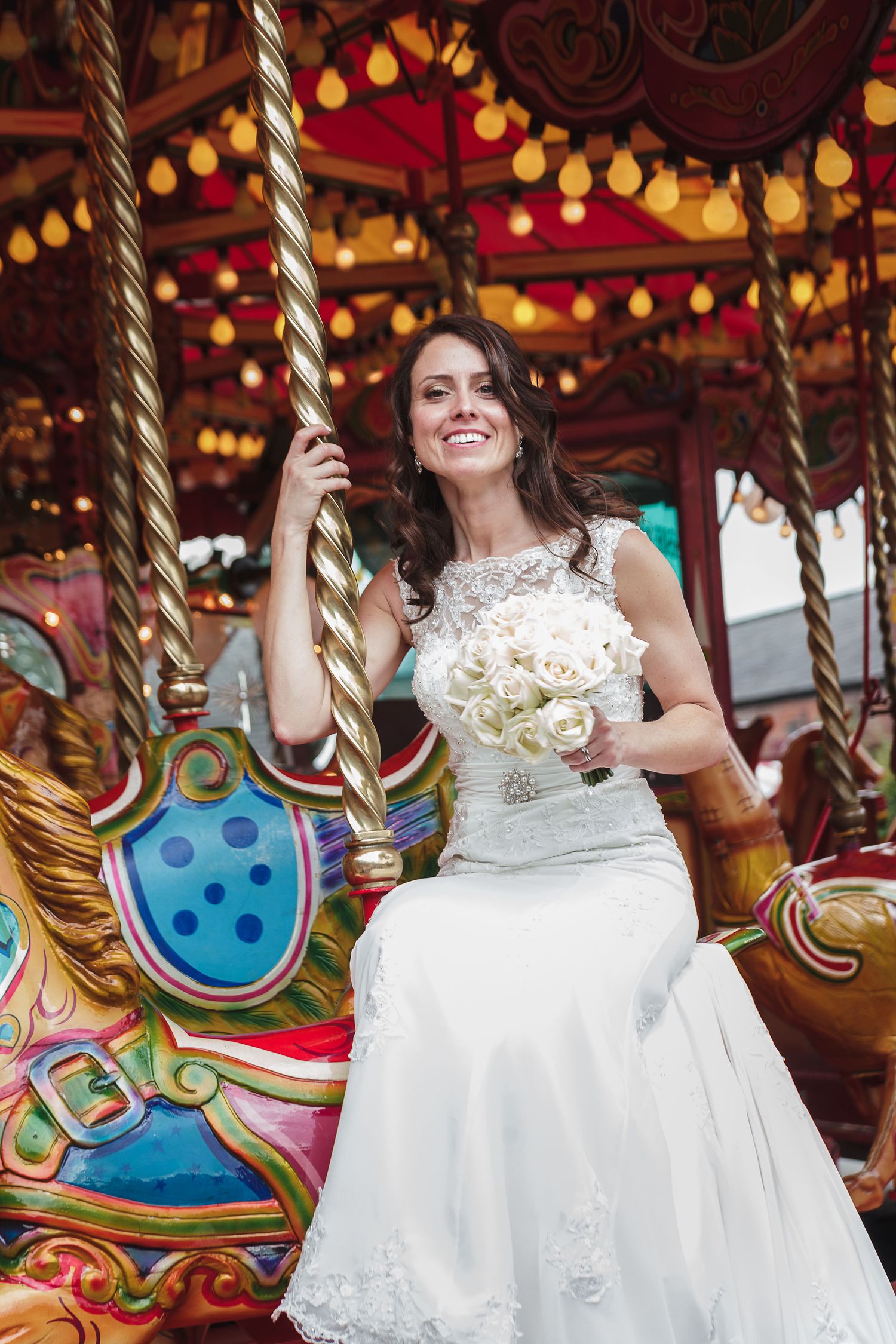 Vintage carousel with colorful lights and decorative details at a carnival.