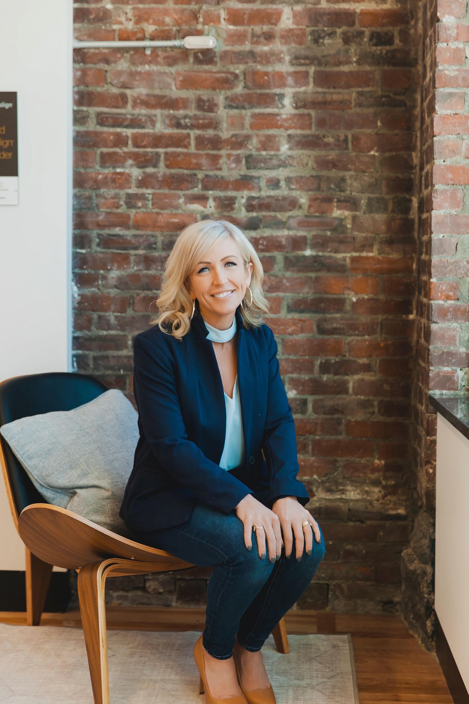 A Maine-based businesswoman smiles as she shares her latest Instagram content, reflecting her brand's creativity and pas