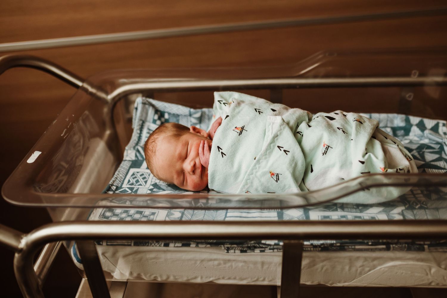 Fresh48 Session newborn baby swaddled in bassinet