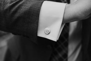 Close-up detail shot of formal wear cufflinks and buttons in black and white.
