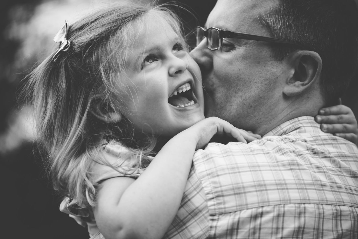 Black and white portrait series capturing intimate family moments and laughter.