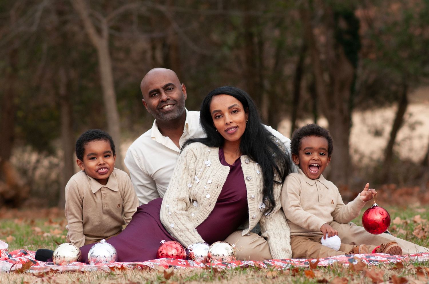 Family pose sitting with holiday ornaments Claude Moore