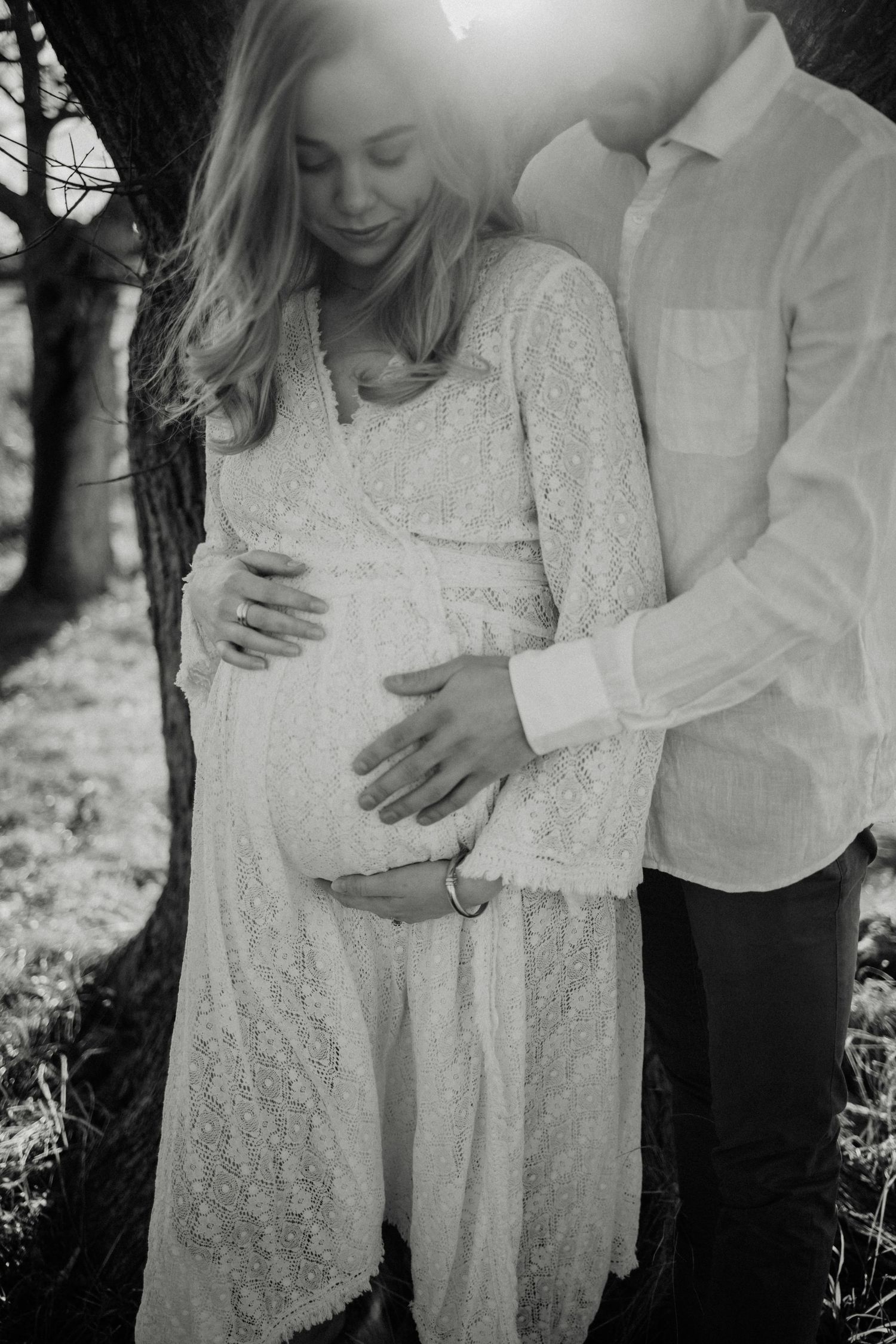 Black and white intimate maternity portrait outdoors.