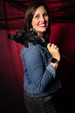 Stylish denim jacket paired with dramatic lighting in a dark studio setting.