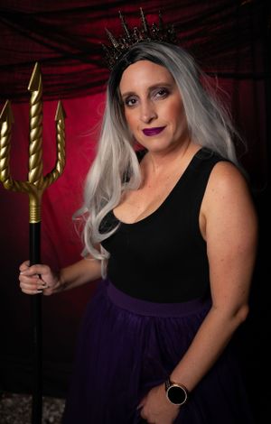 A gothic-inspired photoshoot featuring a black and purple dress with gold accents.