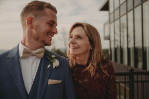 Wedding couple shares tender moment during outdoor portrait session.