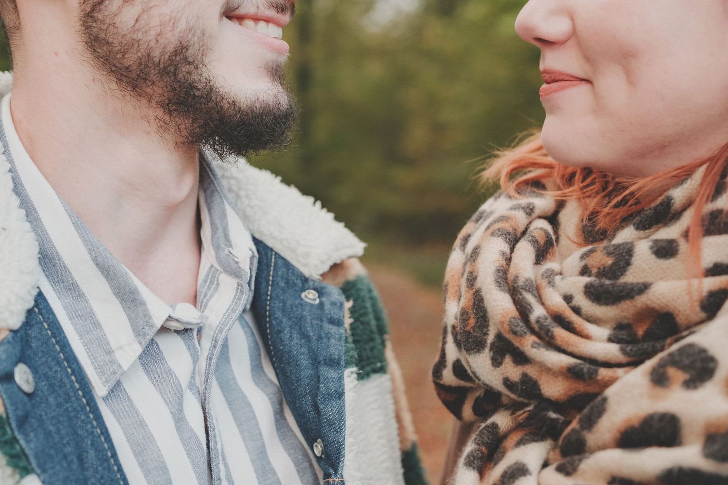 A close-up portrait showing two people in casual attire with a leopard print scarf detail.