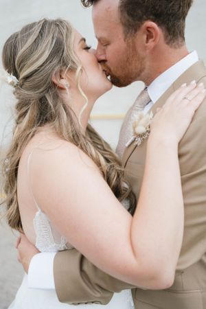 Intimate wedding portrait showing a tender kiss between newlyweds.