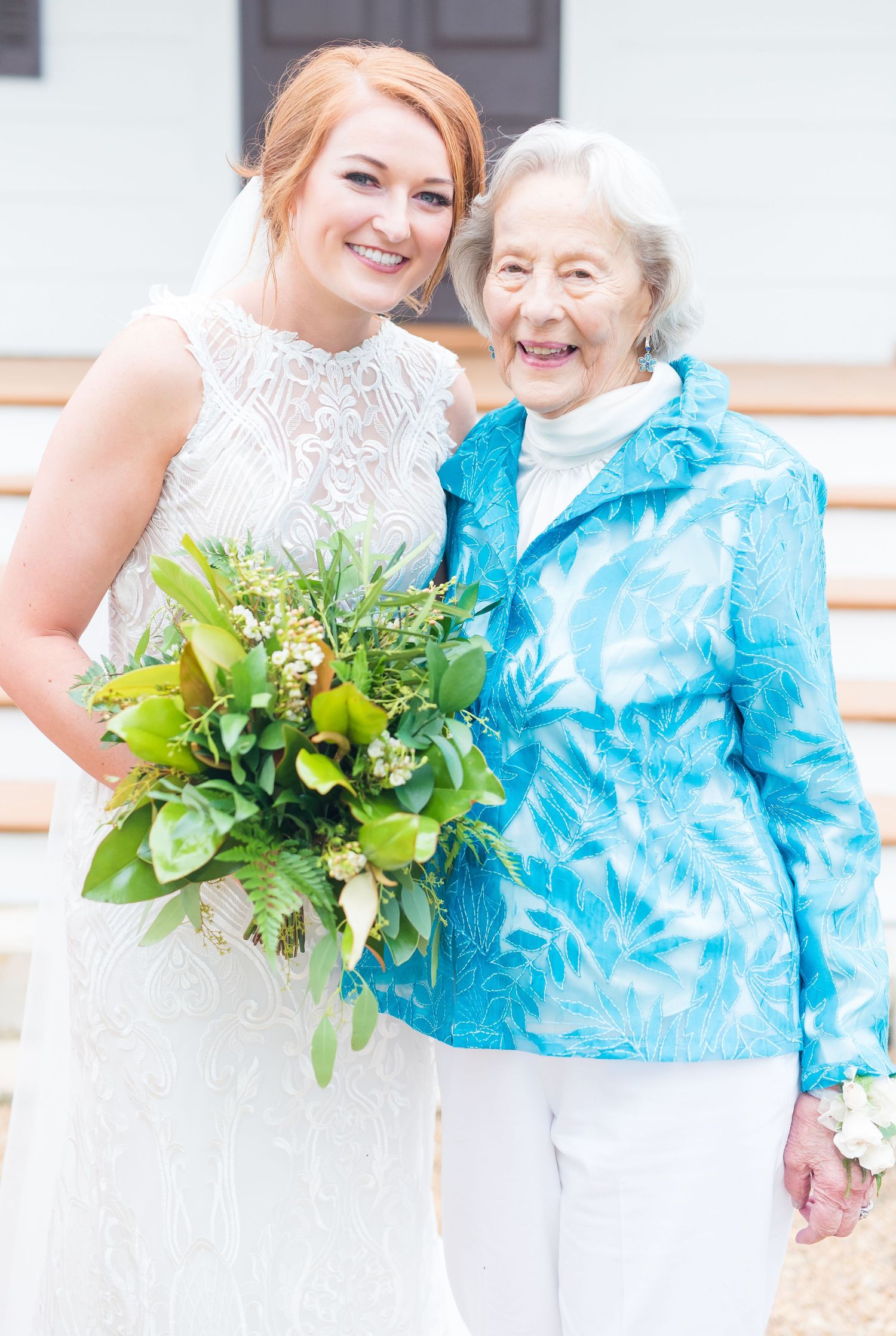 A person in a white wedding dress and someone in a bright turquoise outfit share joyful moments together.