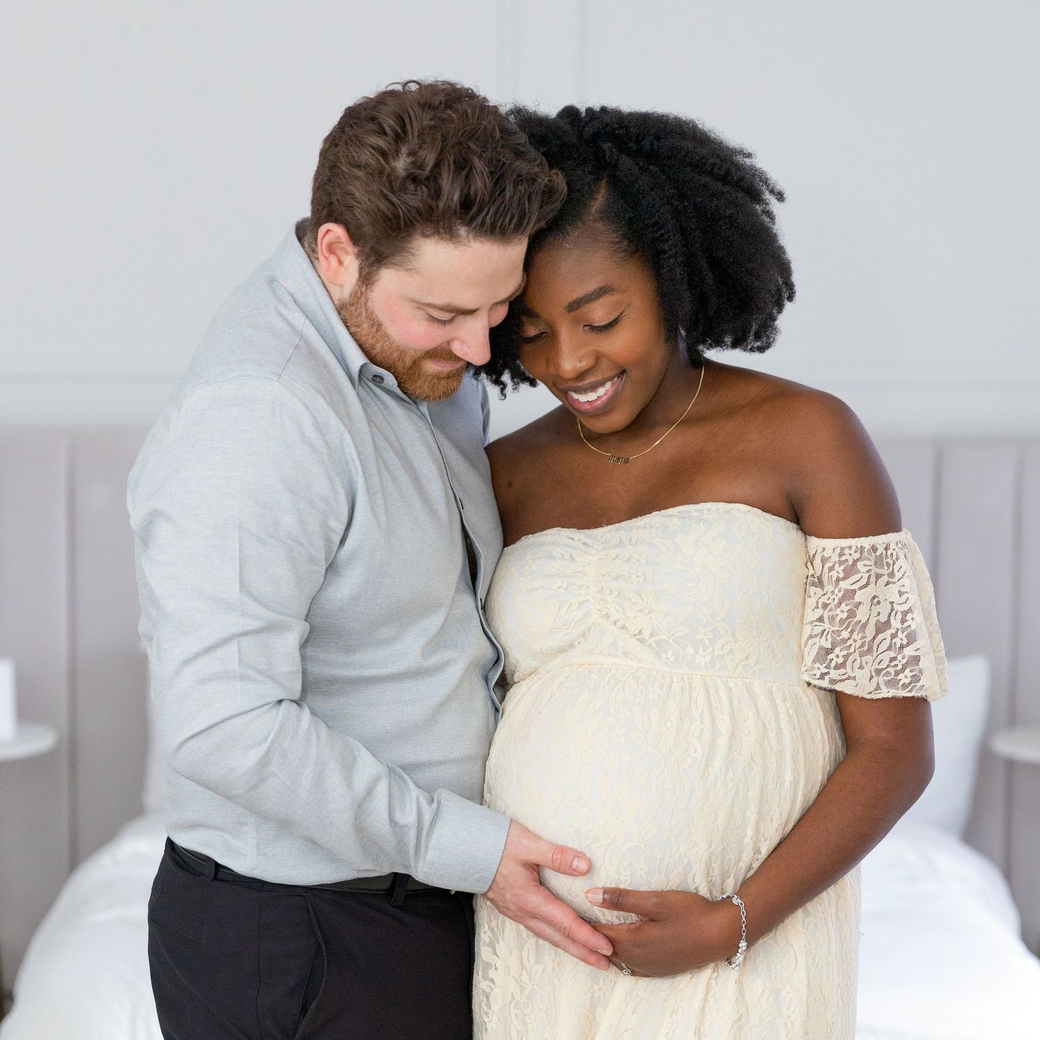 beautiful mint room studio maternity photo session with lace gown dress in a bedroom setting