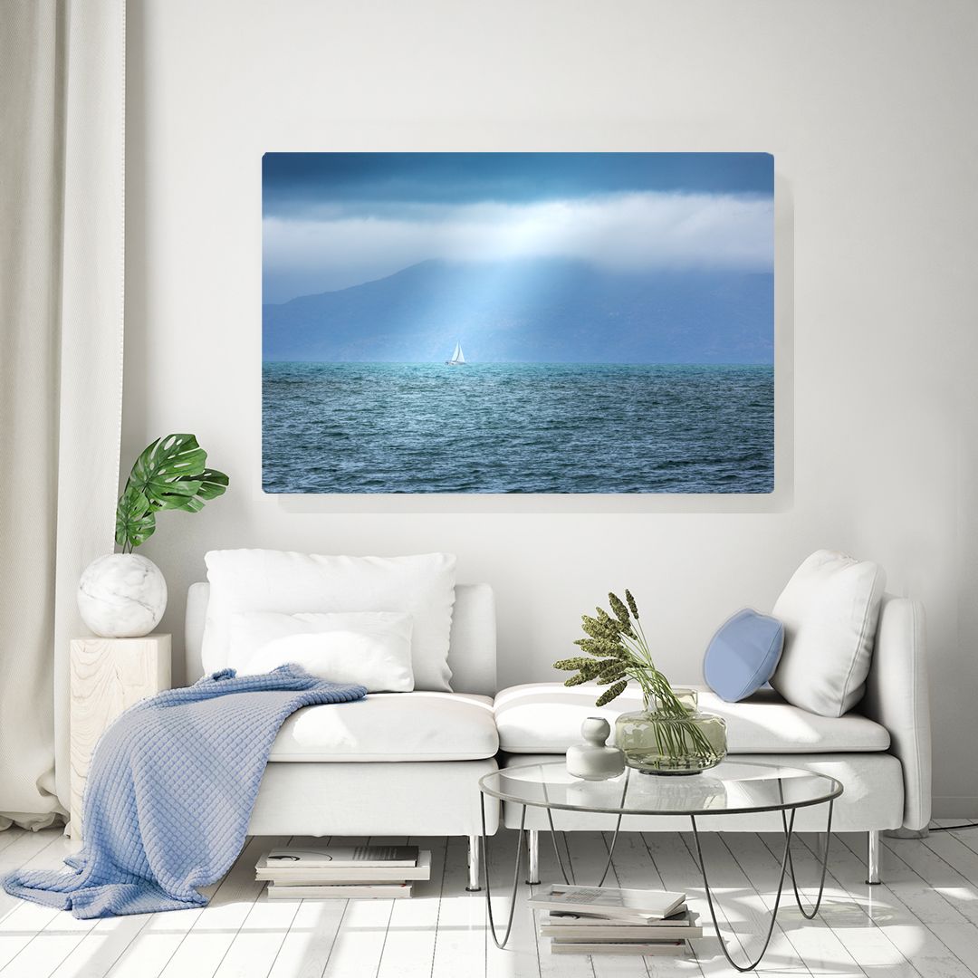 Modern living room interior with coastal artwork featuring dramatic stormy seascape.