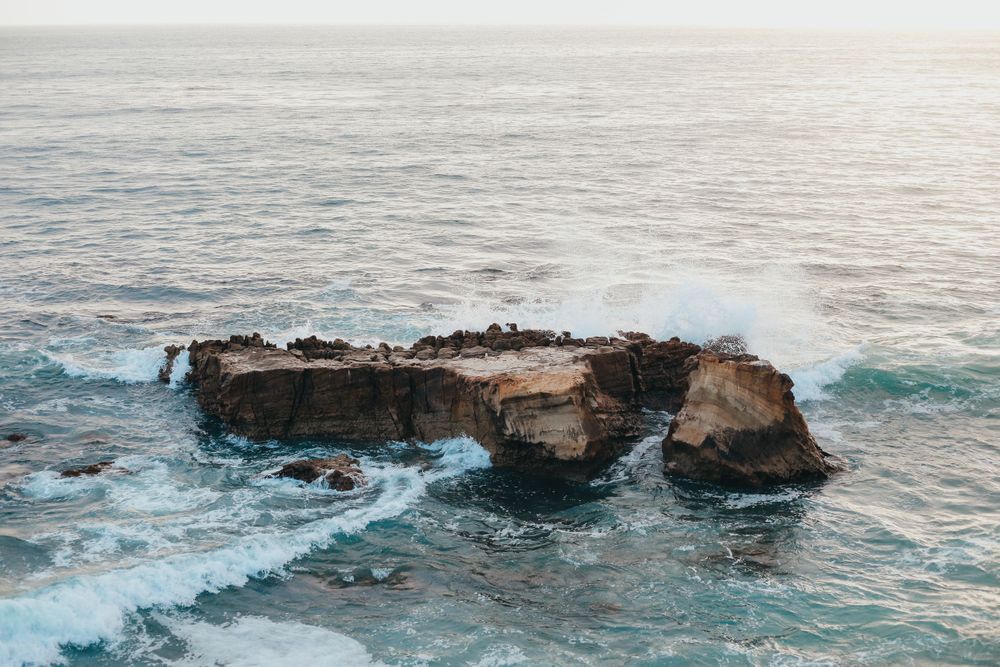 the ocean crashes against rocks in California coast