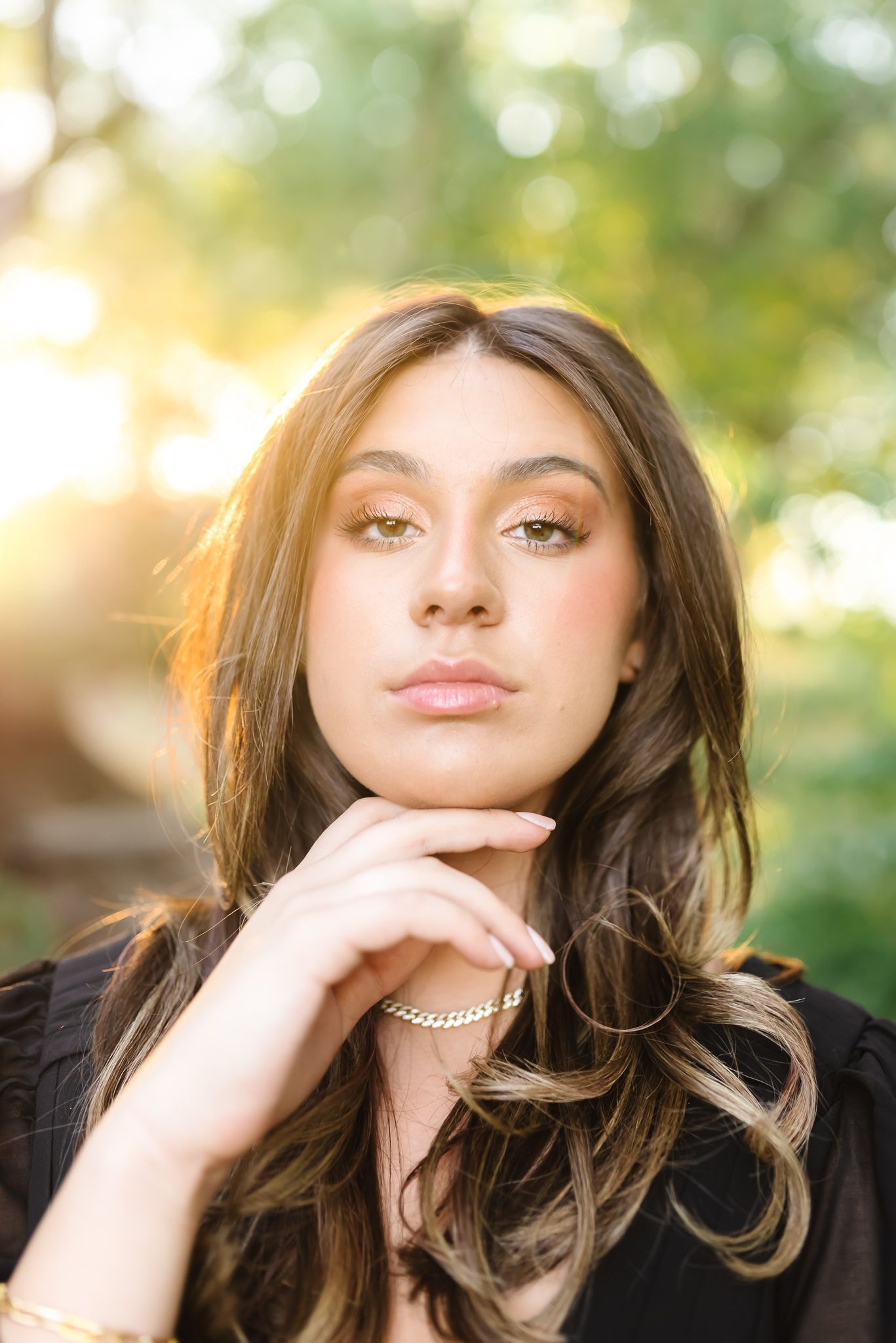 Close-up portraits of a woman with brown hair wearing a pearl necklace in different poses.