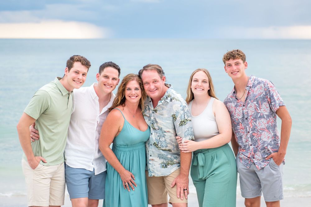 professional family photo at beach 6 people smiling