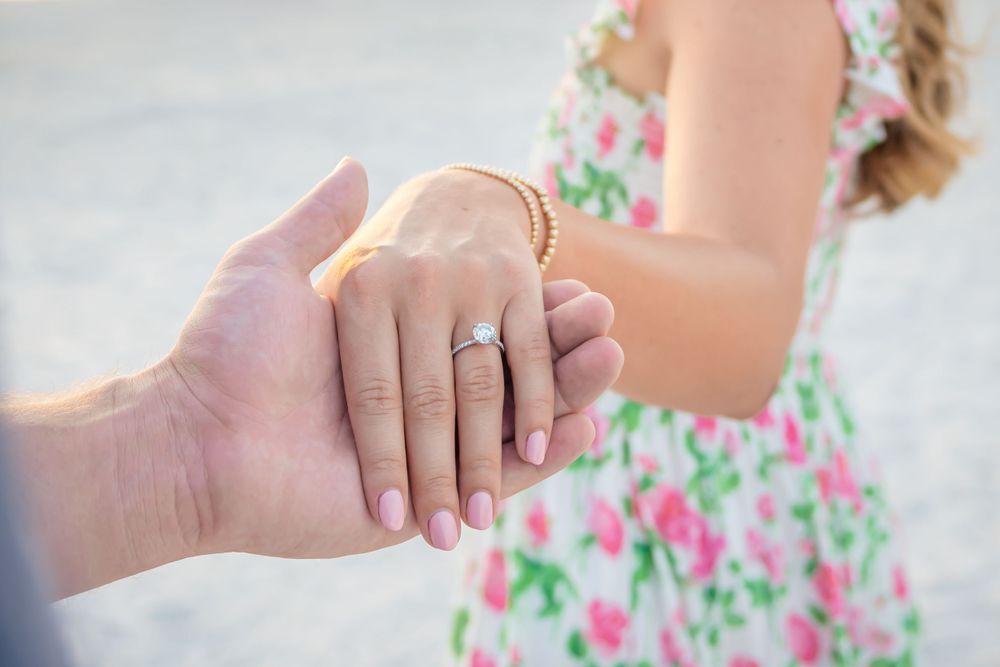 engagement photography at beach rings and hands