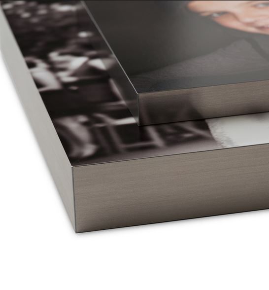 Close-up detail of metallic photo frame corner showing professional mounting construction.