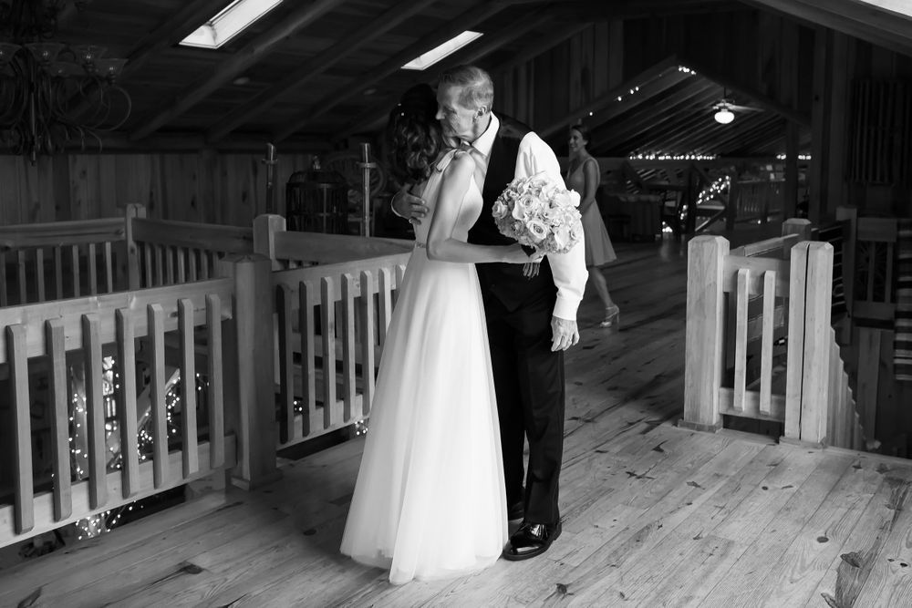 Father hugs daughter on her wedding day at Crystal Brook Farm in Chagrin Falls, Ohio.