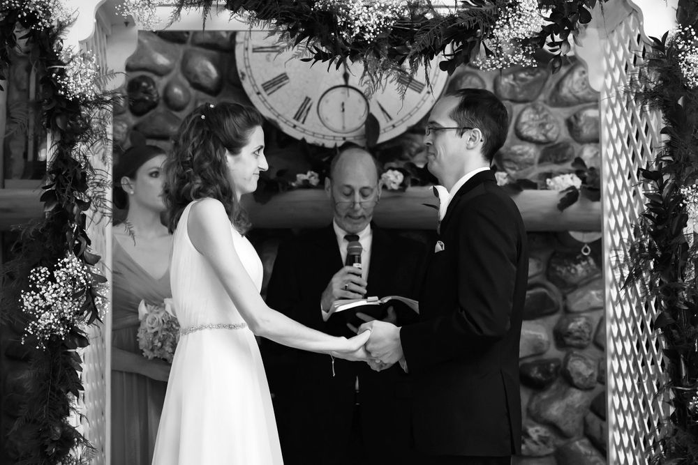 Bride and groom exchange vows during wedding ceremony at Crystal Brook Farm in Chagrin Falls, Ohio.