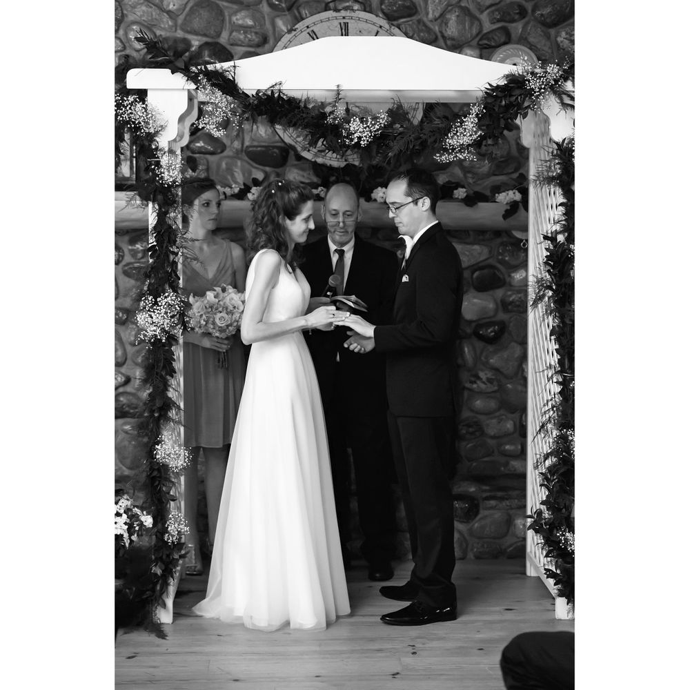 Bride and groom exchange rings during wedding ceremony at Crystal Brook Farm in Chagrin Falls, Ohio.