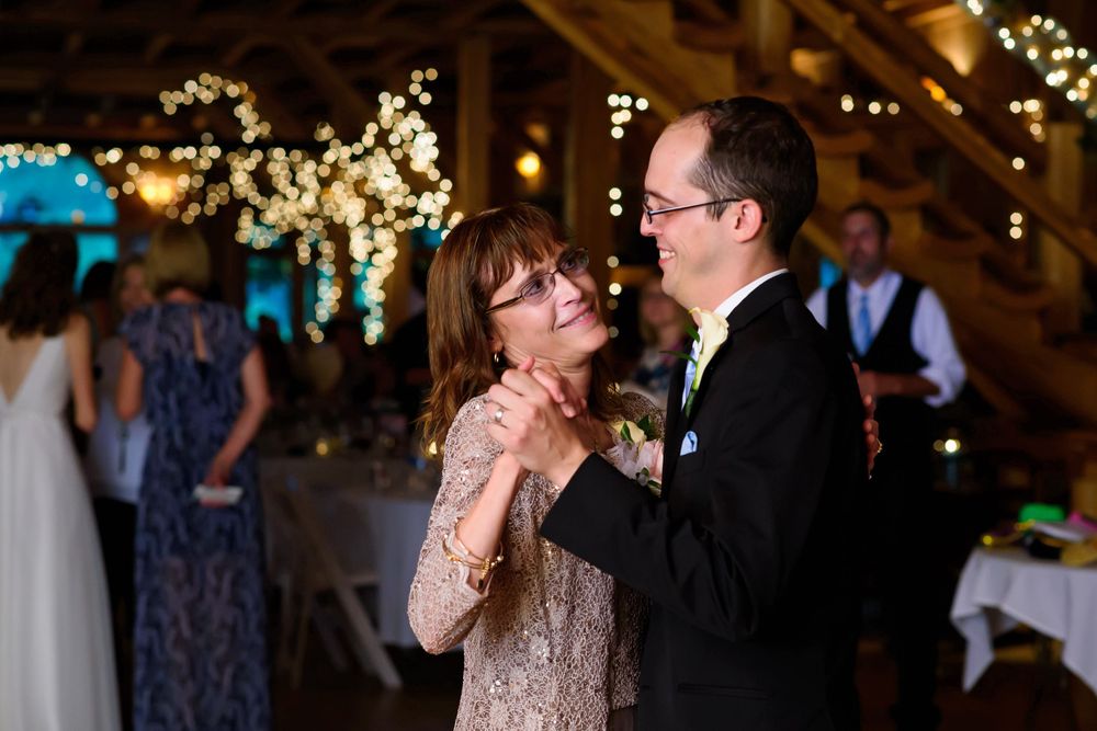 Mother dances with groom during wedding reception at Crystal Brook Farm in Chagrin Falls, Ohio.